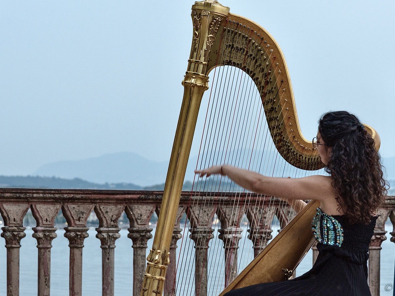 Irene Pauletto performing outdoors by a lake